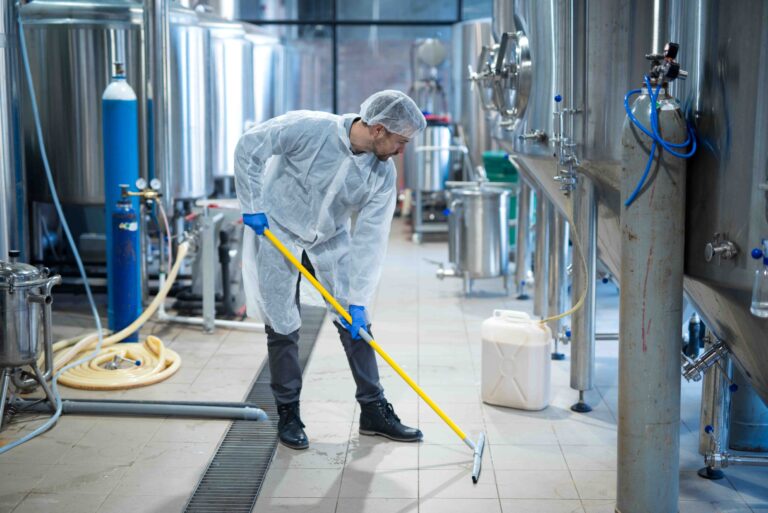 The people cleaning floor with machine.
