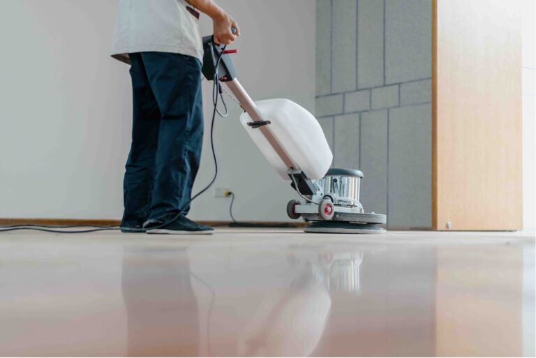 The people cleaning floor with machine.