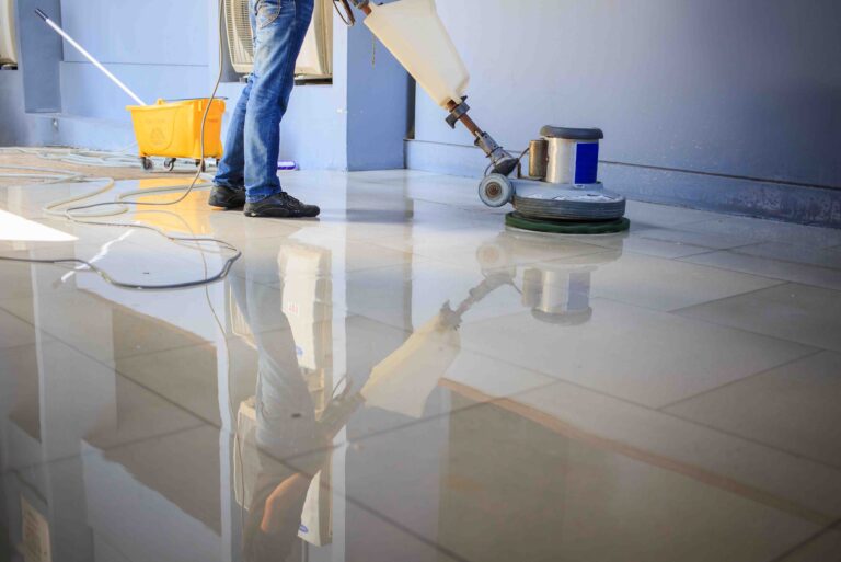 The people cleaning floor with machine.