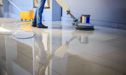 The people cleaning floor with machine.